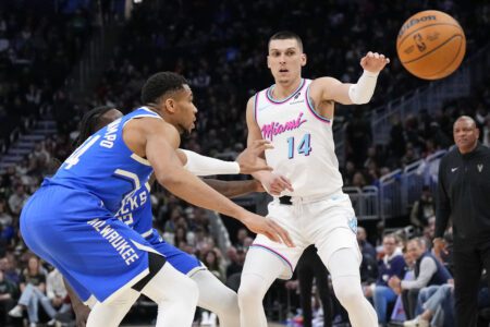 Feb 23, 2025; Milwaukee, Wisconsin, USA; Miami Heat guard Tyler Herro (14) passes the ball away from Milwaukee Bucks forward Giannis Antetokounmpo (34) during the third quarter at Fiserv Forum. Mandatory Credit: Jeff Hanisch-Imagn Images