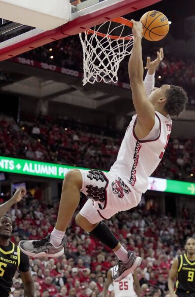 Wisconsin guard John Tonje (9) misses a dunk