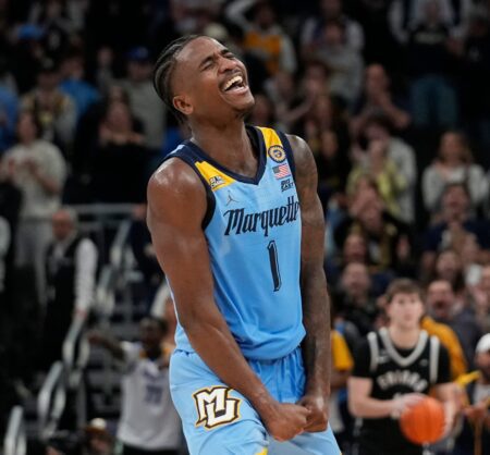 Marquette Golden Eagles guard Kam Jones (1) assists and reacts to the dunk