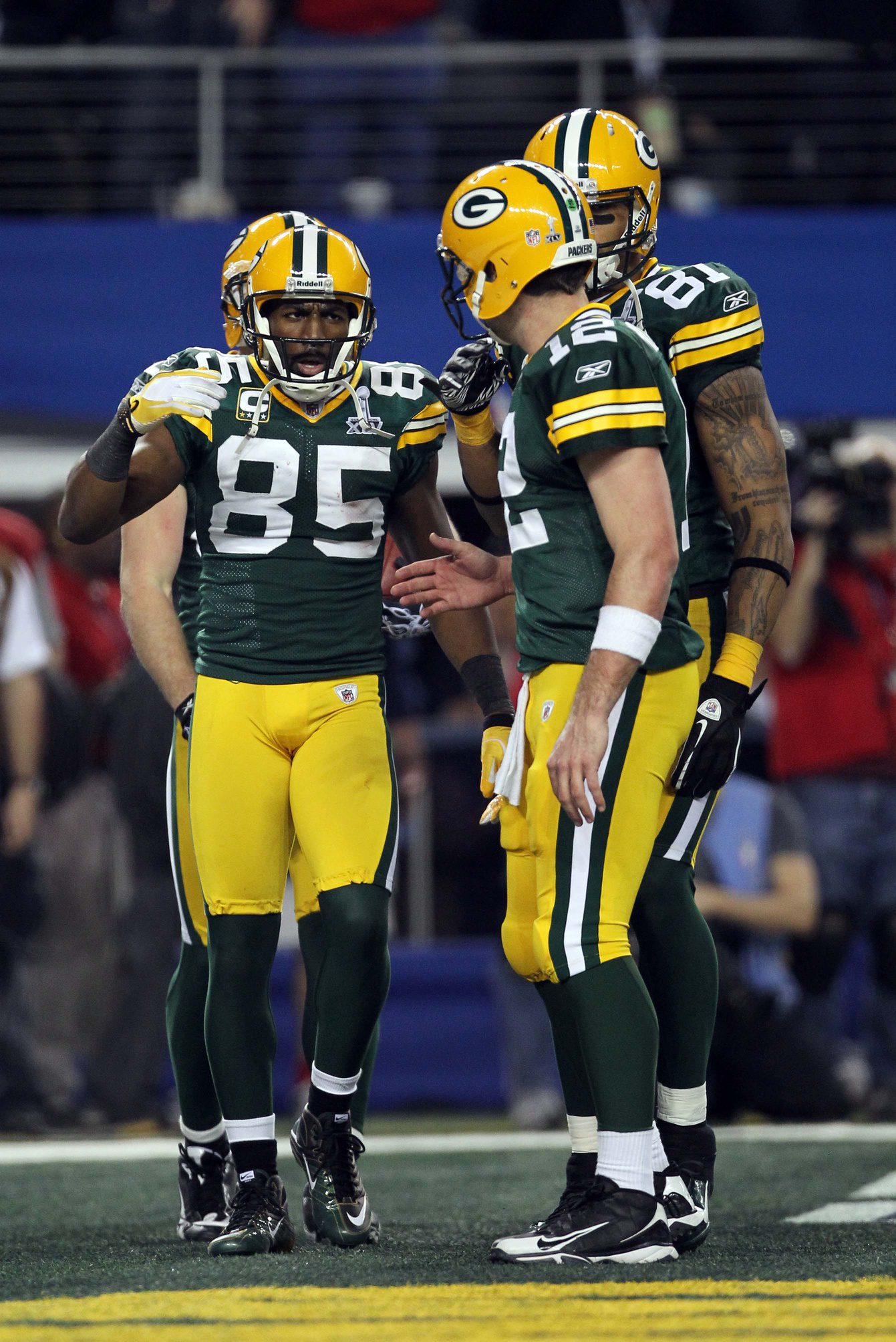 Feb 6, 2011; Arlington, TX, USA; Green Bay Packers wide receiver Greg Jennings (85) is congratulated by quarterback Aaron Rodgers (12) after a touchdown during the second half of Super Bowl XLV against the Pittsburgh Steelers at Cowboys Stadium. Mandatory Credit: Matthew Emmons-Imagn Images