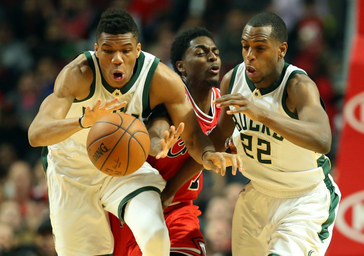 Mar 7, 2016; Chicago, IL, USA; Milwaukee Bucks forward Giannis Antetokounmpo (34), Milwaukee Bucks guard Khris Middleton (22) and Chicago Bulls guard Justin Holiday (7) go after a loose ball during the game at United Center. Mandatory Credit: Caylor Arnold-USA TODAY Sports