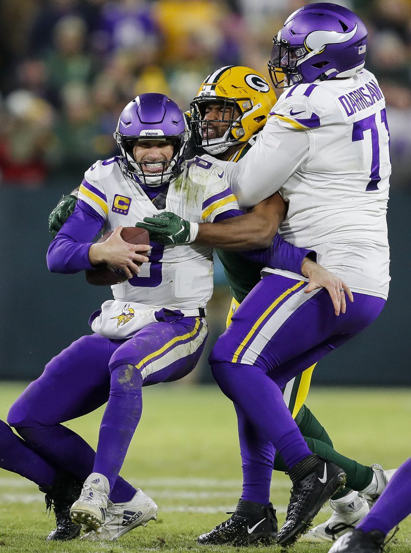 Jan 1, 2023; Green Bay, Wisconsin, USA; Green Bay Packers defensive tackle Jarran Reed sacks Minnesota Vikings quarterback Kirk Cousins (8) at Lambeau Field. Mandatory Credit: Tork Mason-Imagn Images