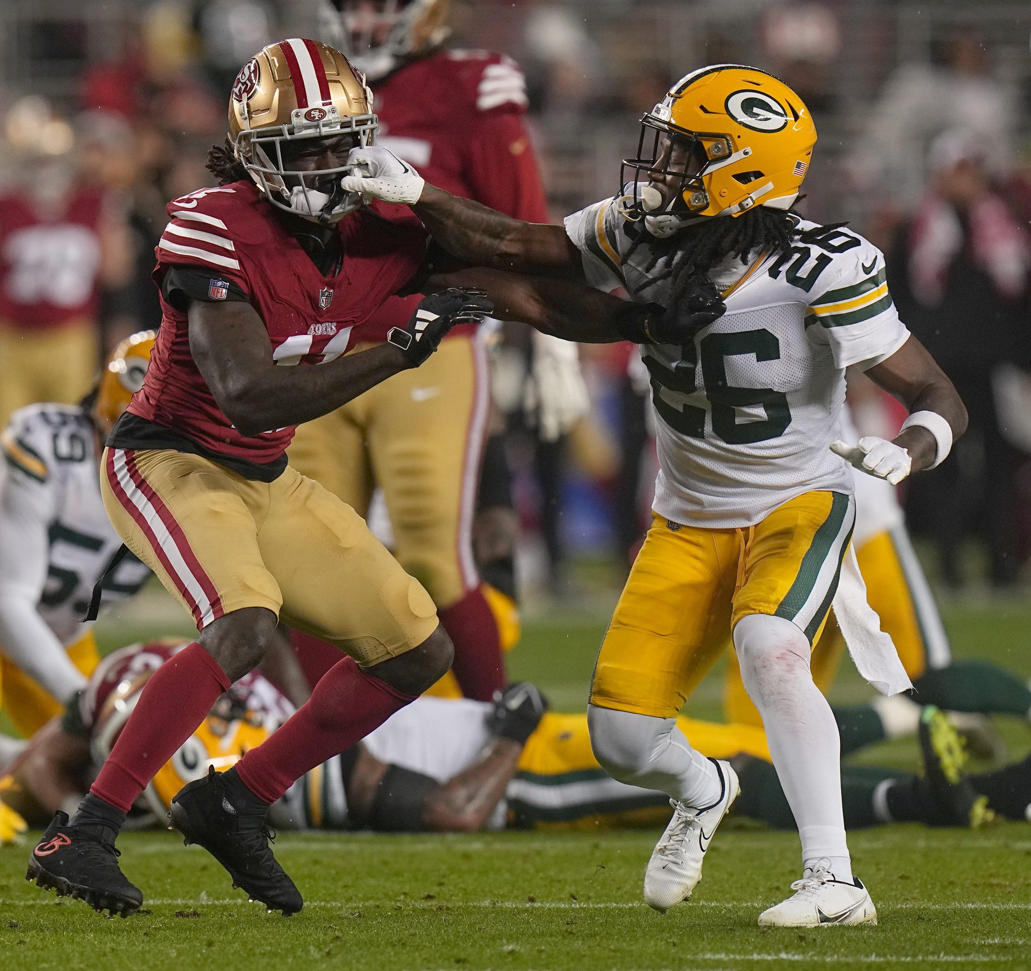 San Francisco 49ers wide receiver Brandon Aiyuk (11) and Green Bay Packers safety Darnell Savage (26) mix it up during the first quarter of their NFC divisional playoff game Saturday, January 20, 2024 at Levi’ Stadium in Santa Clara, California. © Mark Hoffman / Milwaukee Journal Sentinel / USA TODAY NETWORK