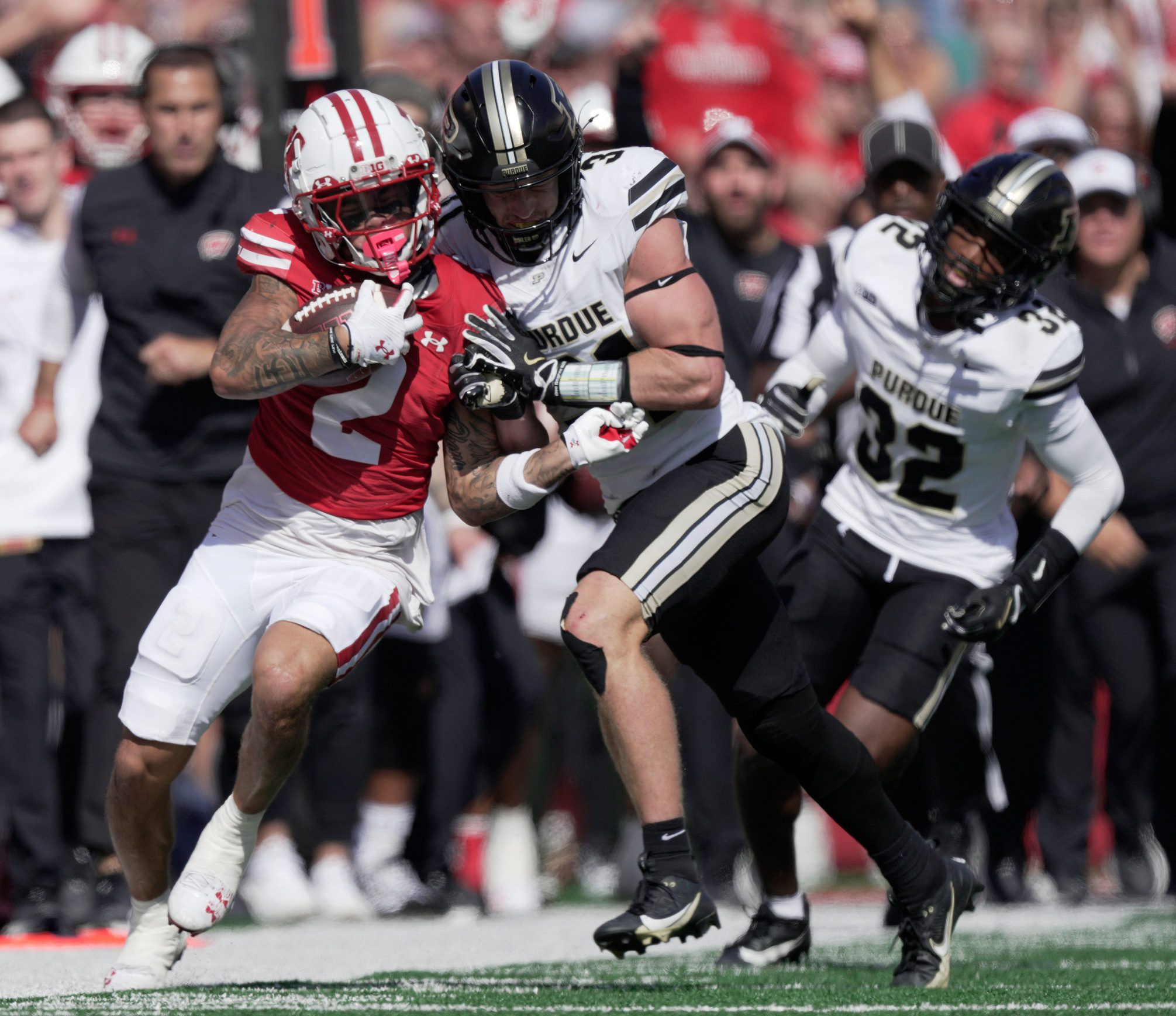 Wisconsin wide receiver Trech Kekahuna (2) picks up 29 yards on a run before being shoved out of bounds by Purdue defensive back Dillon Thieneman (31) during the second quarter of their game Saturday, October 5, 2024, at Camp Randall Stadium in Madison. Wisconsin. © Mark Hoffman / Milwaukee Journal Sentinel / USA TODAY NETWORK via Imagn Images