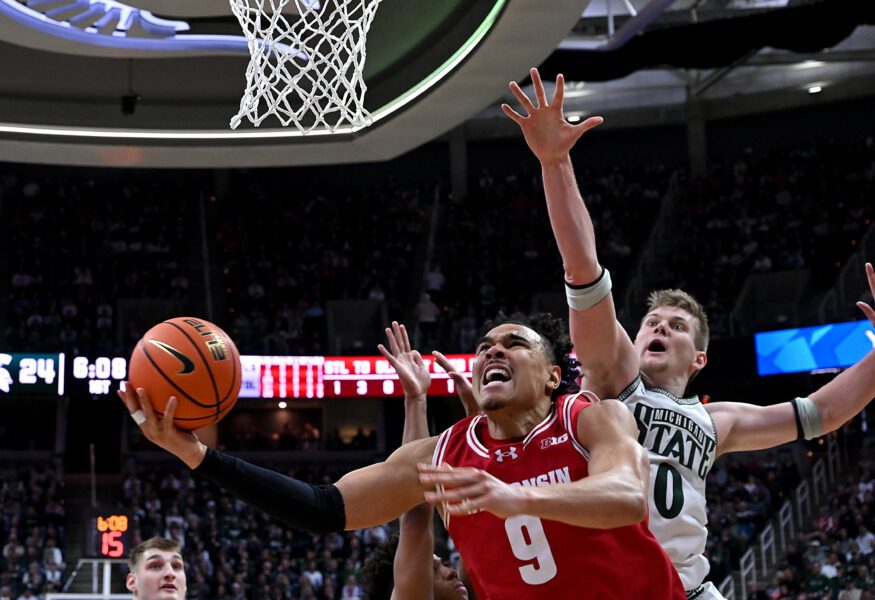 Wisconsin basketball guard John Tonje (9) slashes past Michigan State Spartans forward Jaxon Kohler (0)