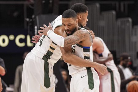 Milwaukee Bucks forward Giannis Antetokounmpo (34) and guard Damian Lillard (0) react