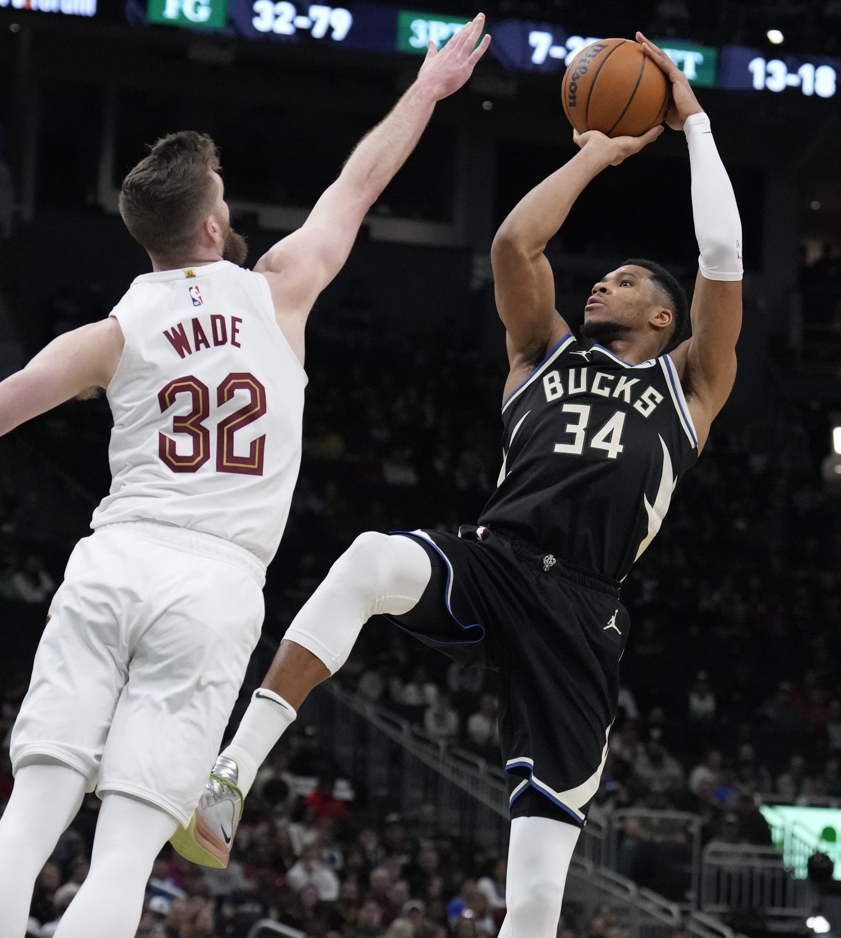 Mar 9, 2025; Milwaukee, Wisconsin, USA; Milwaukee Bucks forward Giannis Antetokounmpo (34) puts up a shot against Cleveland Cavaliers forward Dean Wade (32) in the second half at Fiserv Forum. Mandatory Credit: Michael McLoone-Imagn Images