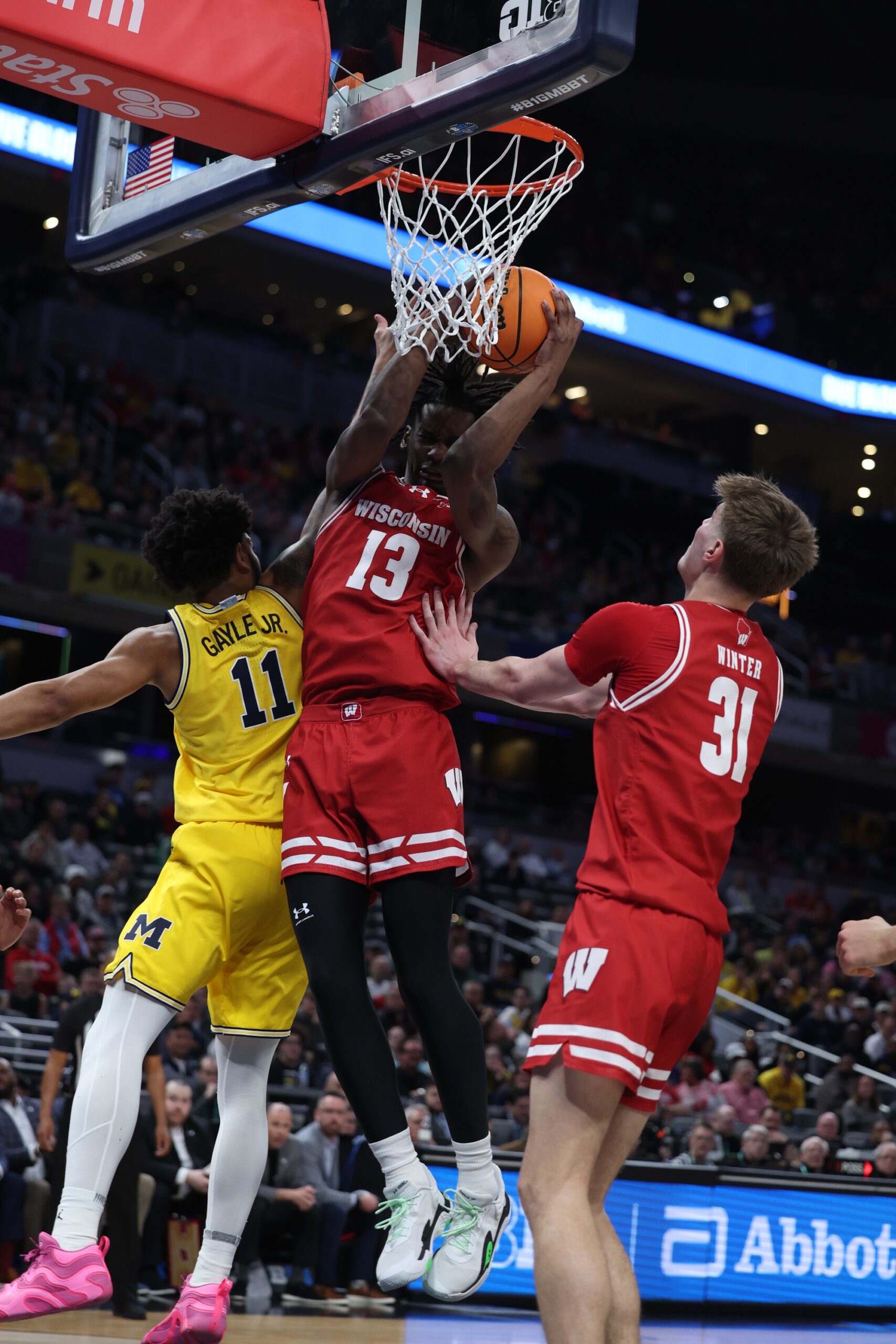 Mar 16, 2025; Indianapolis, IN, USA; Wisconsin Badgers forward Xavier Amos (13) drives to the hoop past Michigan Wolverines guard Roddy Gayle Jr. (11) during the first half during the 2025 Big Ten Championship Game at Gainbridge Fieldhouse. Mandatory Credit: Trevor Ruszkowski-Imagn Images