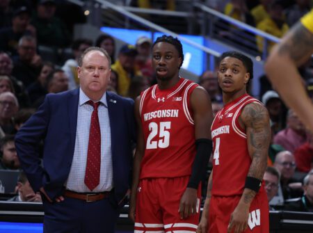 Mar 16, 2025; Indianapolis, IN, USA; Wisconsin Badgers head coach Greg Gard, guard John Blackwell (25) and guard Kamari McGee (4) talk during a pause in play during the second half against the Michigan Wolverines during the 2025 Big Ten Championship Game at Gainbridge Fieldhouse. Mandatory Credit: Trevor Ruszkowski-Imagn Images