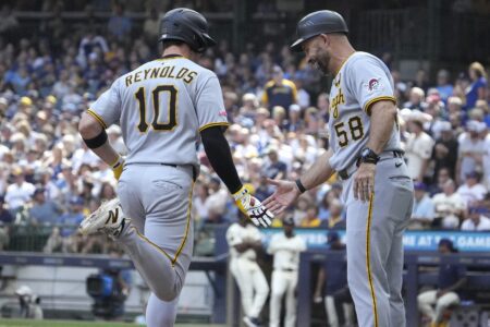 Aug 13, 2025; Milwaukee, Wisconsin, USA; Pittsburgh Pirates outfielder Bryan Reynolds (10) is congratulated by third base coach Mike Rabelo (58) after hitting a home run against the Milwaukee Brewers in the sixth inning at American Family Field. Mandatory Credit: Michael McLoone-Imagn Images