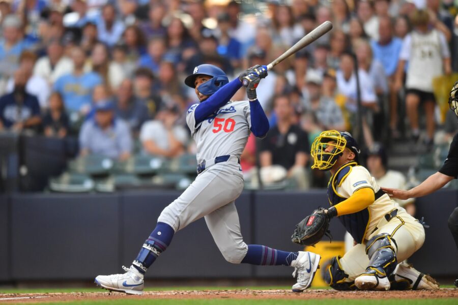 Jul 9, 2025; Milwaukee, Wisconsin, USA; Los Angeles Dodgers shortstop Mookie Betts (50) hits a sacrifice fly RBI during the seventh inning against the Milwaukee Brewers at American Family Field. Mandatory Credit: Patrick Gorski-Imagn Images