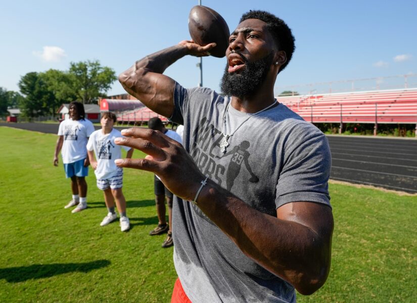 Nate Hobbs works with aspiring young football players at the camp that bears his name. The camp was held at Waggener High School on Saturday, July 13, 2024