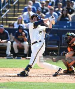 MARYVALE, ARIZONA - MARCH 06: Jedd Gyorko #5 of the Milwaukee Brewers follows through on a swing during a spring training game against the San Francisco Giants at American Family Fields of Phoenix on March 06, 2020 in Maryvale, Arizona. (Photo by Norm Hall/Getty Images)