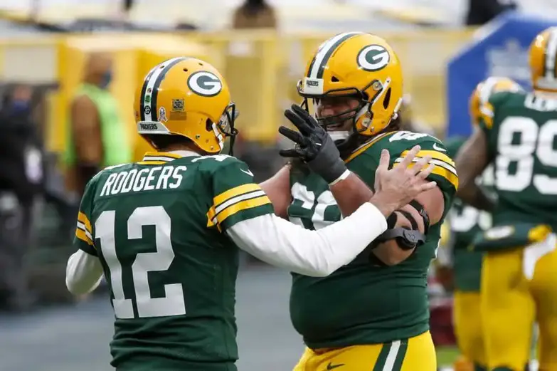 Green Bay Packers' Aaron Rodgers celebrates his touchdown run with David Bakhtiari during the first half of an NFL football game against the Jacksonville Jaguars Sunday, Nov. 15, 2020, in Green Bay, Wis. (AP Photo/Matt Ludtke) NFL News