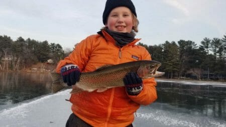 A young Wisconsin angler with a beautiful Rainbow Trout caught by suspending a fathead under a tip-up just off the break.