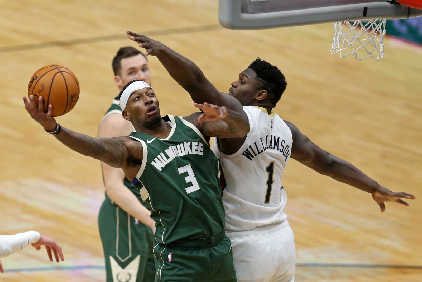 Dec 18, 2020; New Orleans, Louisiana, USA; Milwaukee Bucks forward Torrey Craig (3) is defended by New Orleans Pelicans forward Zion Williamson (1) in the second half at the Smoothie King Center. Mandatory Credit: Chuck Cook-USA TODAY Sports (NBA News)