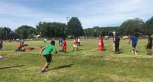gilbert brown football camp boy practicing with coach