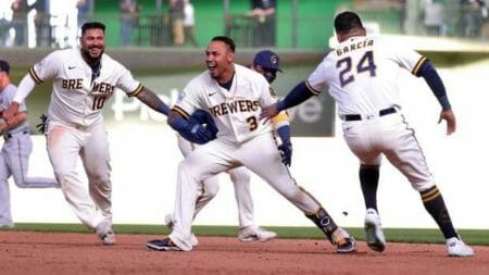 Orlando Arcia of the Milwaukee Brewers celebrates with teammates after driving in the game winning run during the tenth inning against the Minnesota Twins on Opening Day at American Family Field on April 01, 2021 in Milwaukee, Wisconsin. (Photo by Stacy Revere/Getty Images)
