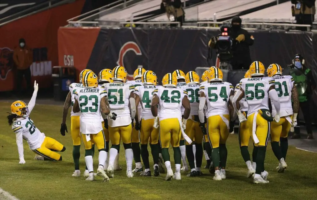 Members of the Green Bay Packer defense celebrate after an interception against the Chicago Bears at Soldier Field