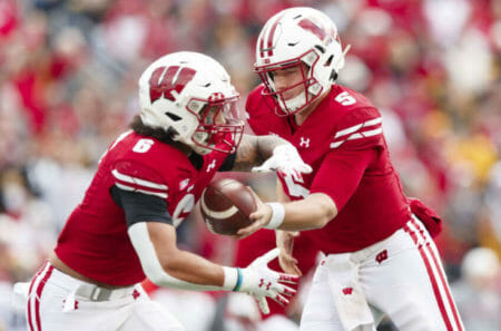 Oct 30, 2021; Madison, Wisconsin, USA; Wisconsin Badgers quarterback Graham Mertz (5) hands the football off to running back Chez Mellusi (6) during the first quarter against the Iowa Hawkeyes at Camp Randall Stadium. Mandatory (Jeff Hanisch / USA TODAY Sports)