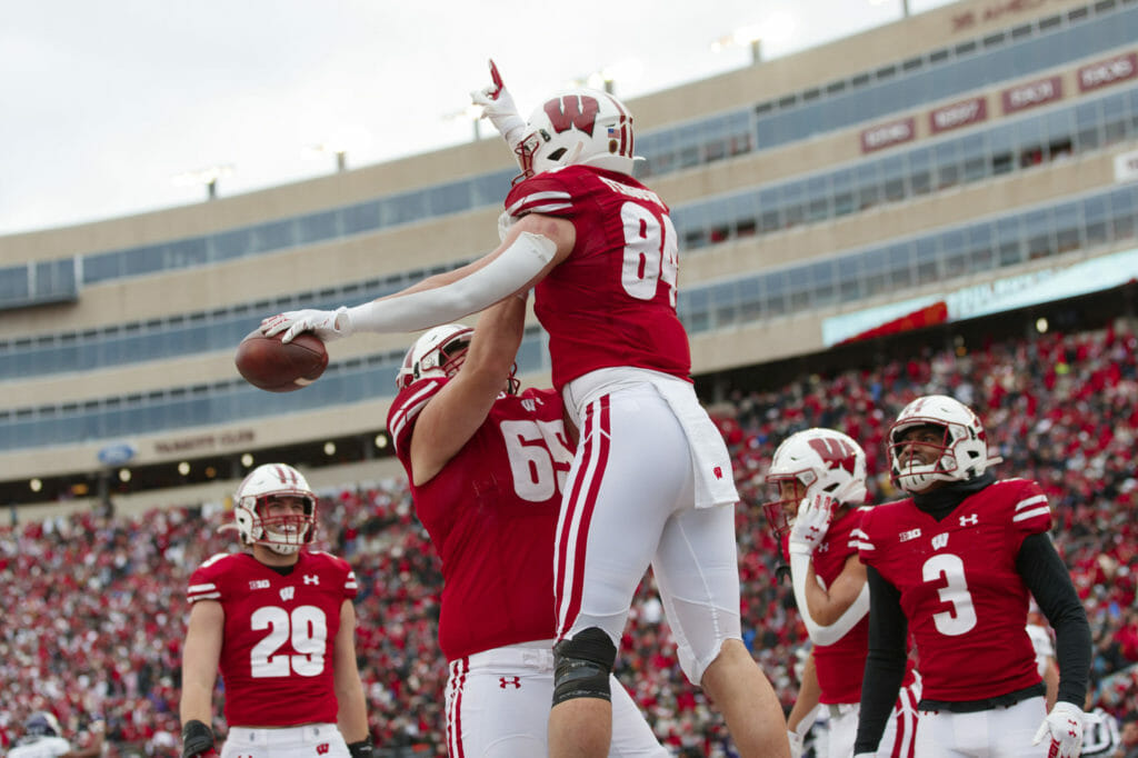 Nov 13, 2021; Madison, Wisconsin, USA; Wisconsin Badgers tight end Jake Ferguson (84) celebrates with offensive linenam Tyler Beach (65) after scoring a touchdown during the third quarter against the Northwestern Wildcats at Camp Randall Stadium. Mandatory Credit: Jeff Hanisch-USA TODAY Sports