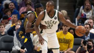 Khris Middleton of the Milwaukee Bucks is guarded by an Indiana Pacers player.