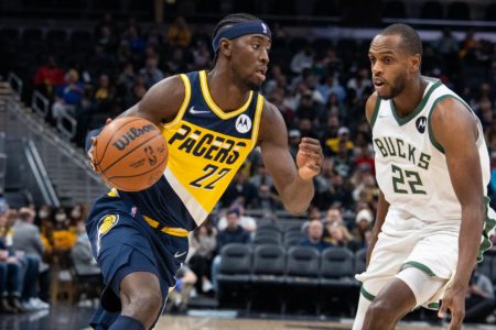 Indiana Pacers' Caris LeVert is guarded by Milwaukee Bucks' Khris Middleton.