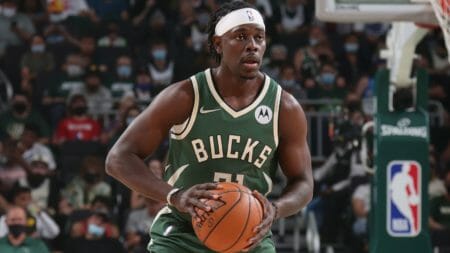 Jrue Holiday holds a basketball during a game with the Milwaukee Bucks.