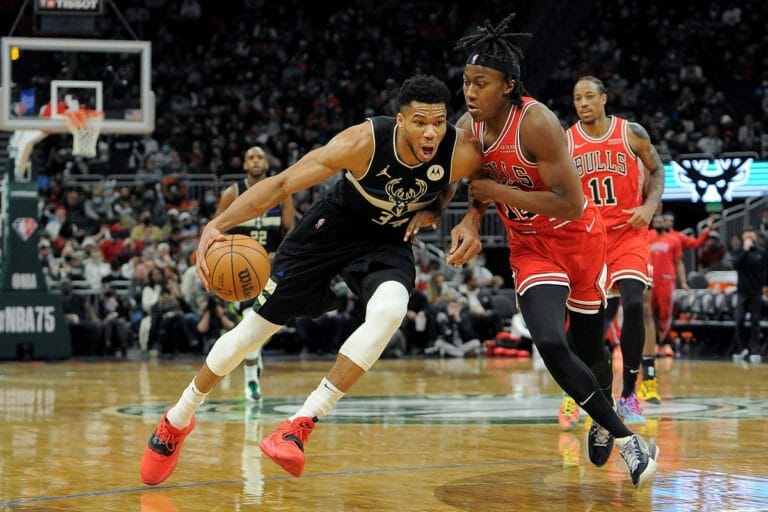 Giannis Antetokounmpo of the Milwaukee Bucks is guarded by a Chicago Bulls player.