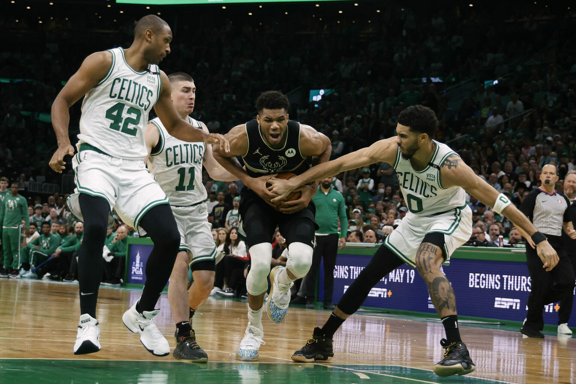 May 15, 2022; Boston, Massachusetts, USA; Milwaukee Bucks forward Giannis Antetokounmpo (34) tries to go between Boston Celtics forward Jayson Tatum (0), guard Payton Pritchard (11) and center Al Horford (42) during the second half of game seven of the second round of the 2022 NBA playoffs at TD Garden. Mandatory Credit: Winslow Townson-USA TODAY Sports (NBA News)