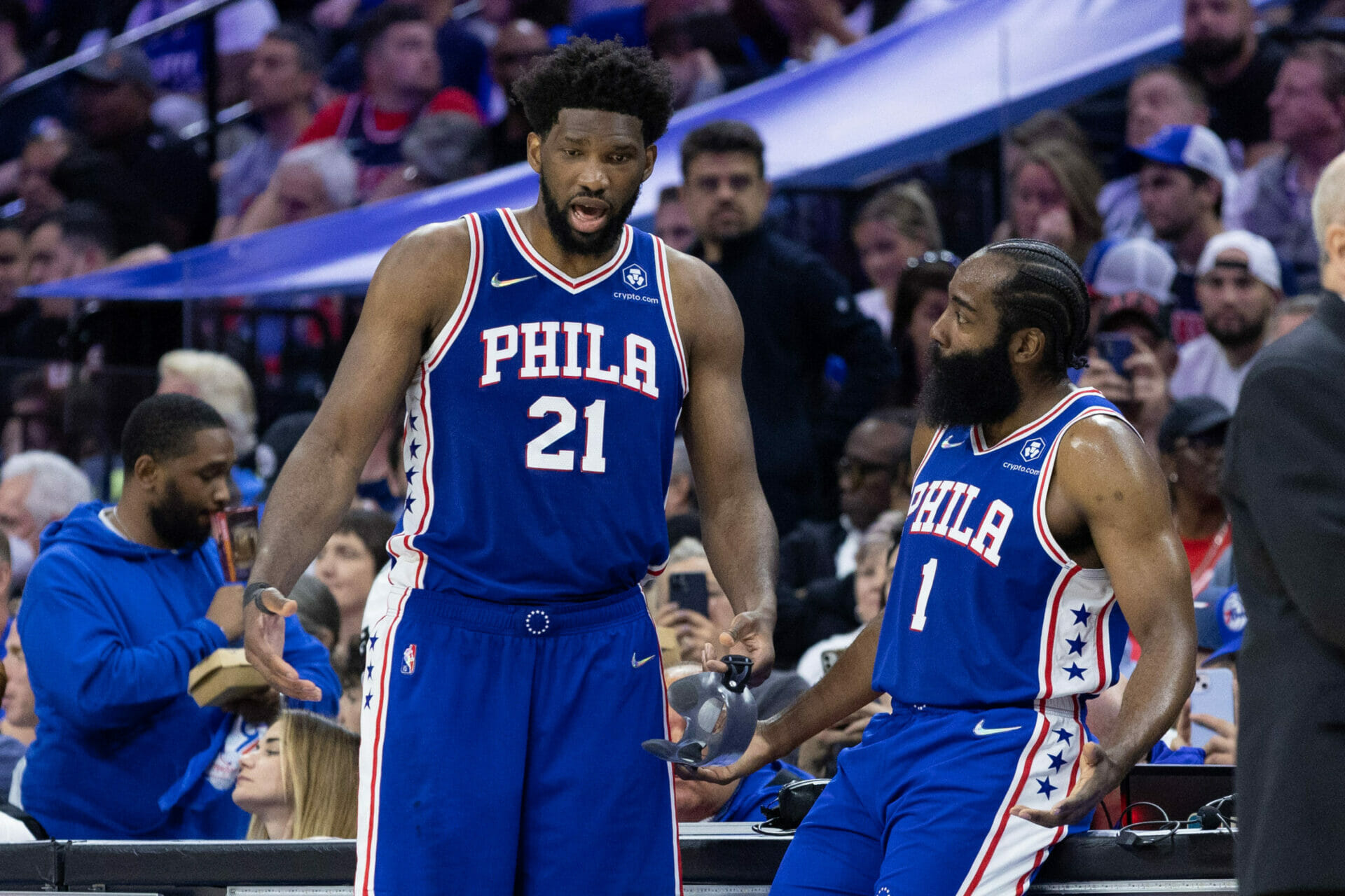 May 12, 2022; Philadelphia, Pennsylvania, USA; Philadelphia 76ers center Joel Embiid (21) and guard James Harden (1) talk during the fourth quarter against the Miami Heat in game six of the second round of the 2022 NBA playoffs at Wells Fargo Center. Mandatory Credit: Bill Streicher-USA TODAY Sports (NBA News)