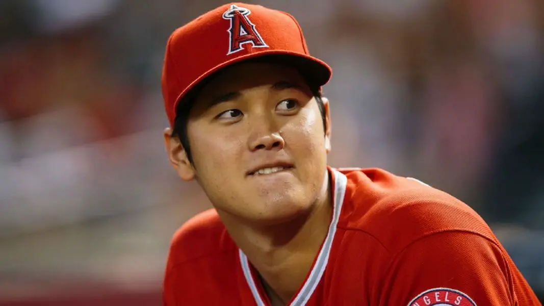 Shohei Ohtani watching an Angels game from the dugout