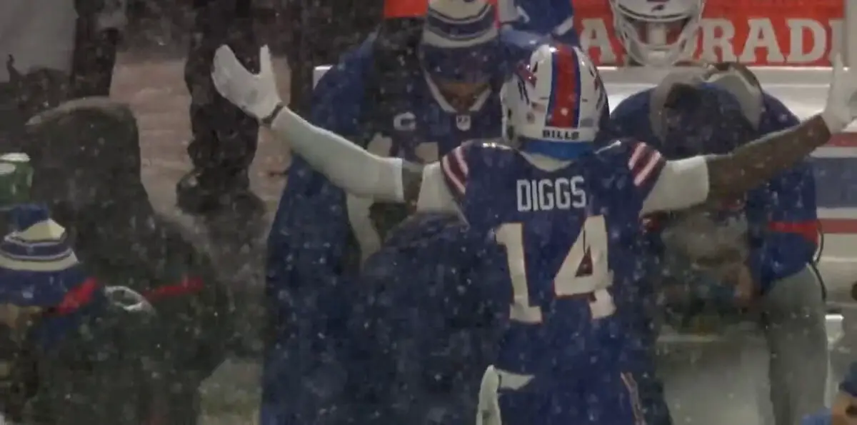Stefon Diggs puts his arms up in front of Josh Allen on sideline