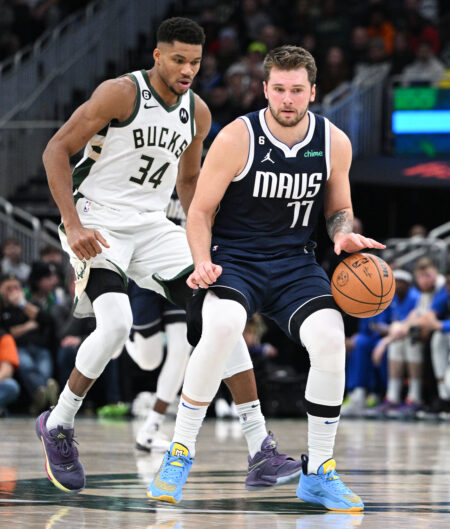 Nov 27, 2022; Milwaukee, Wisconsin, USA; Dallas Mavericks guard Luka Doncic (77) dribbles the ball up court against Milwaukee Bucks forward Giannis Antetokounmpo (34) in the second half at Fiserv Forum. Mandatory Credit: Michael McLoone-USA TODAY Sports
