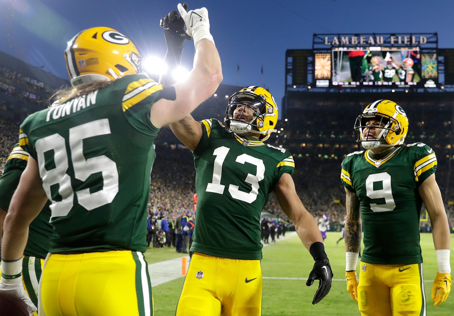 Green Bay Packers tight end Robert Tonyan celebrates with wide receivers Allen Lazard and Christian Watson