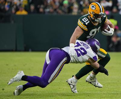 Jan 1, 2023; Green Bay, Wisconsin, USA; Green Bay Packers tight end Josiah Deguara (81) is tackled by Minnesota Vikings safety Harrison Smith (22) after a short gain during the second quarter at Lambeau Field. Mandatory Credit: Mark Hoffman-USA TODAY Sports