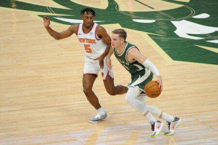 Mar 11, 2021; Milwaukee, Wisconsin, USA; Milwaukee Bucks guard Sam Merrill (15) pushes the ball up court against New York Knicks guard Immanuel Quickley (5) in the fourth quarter at Fiserv Forum. Mandatory Credit: Michael McLoone-USA TODAY Sports (NBA News)