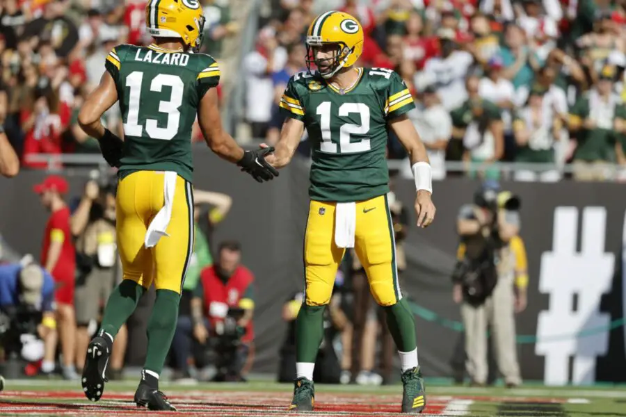 Sep 25, 2022; Tampa, Florida, USA; Green Bay Packers quarterback Aaron Rodgers (12) and wide receiver Allen Lazard (13) congratulate each other after they scored a touchdown against the Tampa Bay Buccaneers during the first quarter at Raymond James Stadium. Mandatory Credit: Kim Klement-USA TODAY Sports