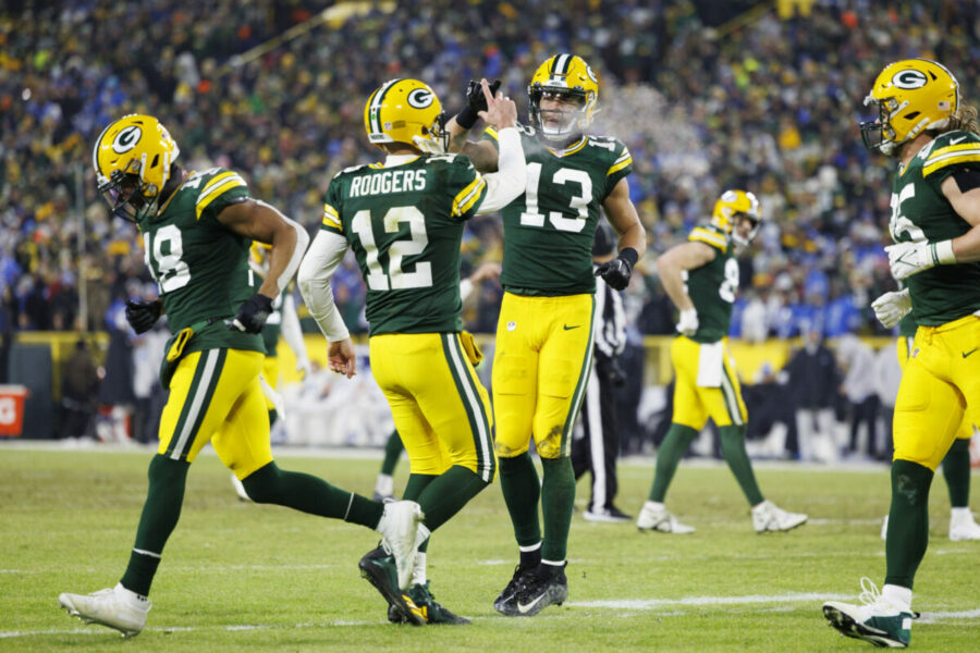 Jan 8, 2023; Green Bay, Wisconsin, USA; Green Bay Packers quarterback Aaron Rodgers (12) celebrates with wide receiver Allen Lazard (13) following a touchdown during the third quarter against the Detroit Lions at Lambeau Field. Mandatory Credit: Jeff Hanisch-USA TODAY Sports