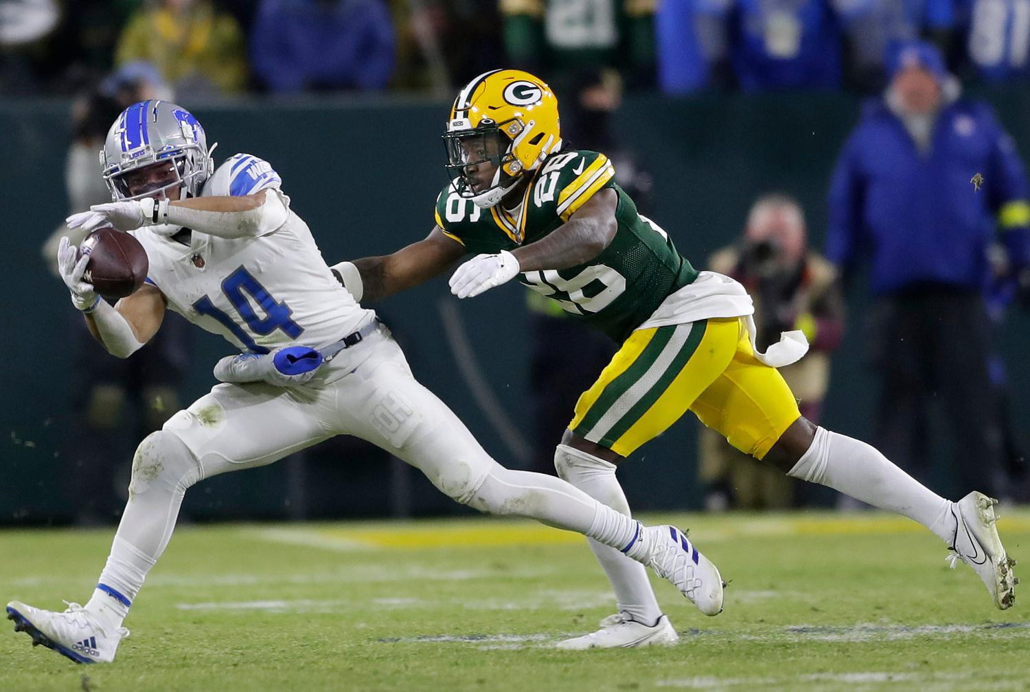 Detroit Lions wide receiver Amon-Ra St. Brown (14) catches a pass in front of Green Bay Packers safety Darnell Savage (26) during their football game on Sunday, January, 8, 2022 at Lambeau Field in Green Bay, Wis. Wm. Glasheen USA TODAY NETWORK-Wisconsin Apc Packers Vs Lions 6166 010823 Wag