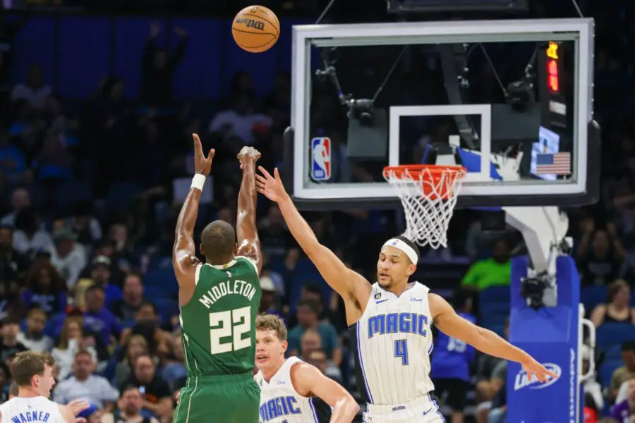 Mar 7, 2023; Orlando, Florida, USA; Milwaukee Bucks forward Khris Middleton (22) shoots the ball over Orlando Magic guard Jalen Suggs (4) during the first quarter at Amway Center. Mandatory Credit: Mike Watters-USA TODAY Sports (NBA News)