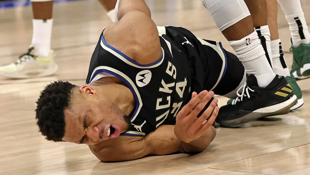 Milwaukee Bucks' Giannis Antetokounmpo lies on the floor after an injury during the first half in Game 1 of an NBA basketball first-round playoff game Sunday, April 16, 2023, in Milwaukee. (AP Photo/Morry Gash)