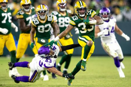Green Bay Packers running back Aaron Jones (33) stiff arms Minnesota Vikings safety Camryn Bynum (43) in the second quarter, Sunday, January 2, 2022, at Lambeau Field in Green Bay, Wis. Samantha Madar/USA TODAY NETWORK-Wis.