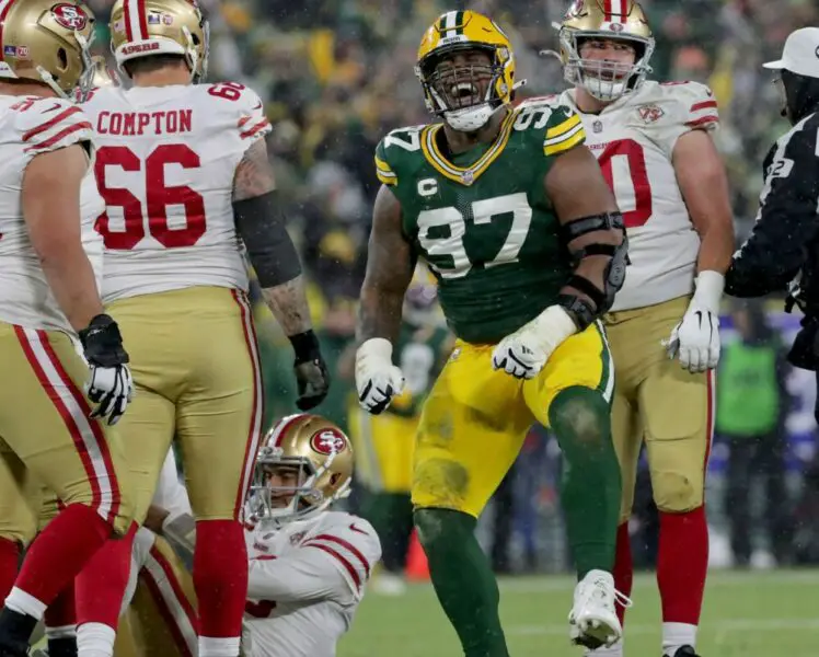 Packers nose tackle Clark (97) celebrates a sack on San Francisco 49ers quarterback Jimmy Garoppolo (10) during the third quarter of the divisional playoff game at Lambeau Field in Green Bay on Saturday, Jan. 22, 2022.