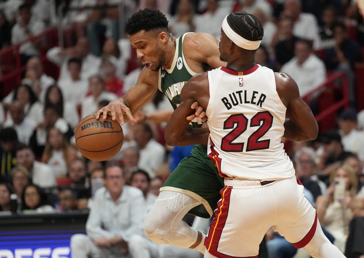 Apr 24, 2023; Miami, Florida, USA; Miami Heat forward Jimmy Butler (22) defends Milwaukee Bucks forward Giannis Antetokounmpo (34) in the first quarter during game four of the 2023 NBA Playoffs at Kaseya Center. Mandatory Credit: Jim Rassol-USA TODAY Sports (NBA News)