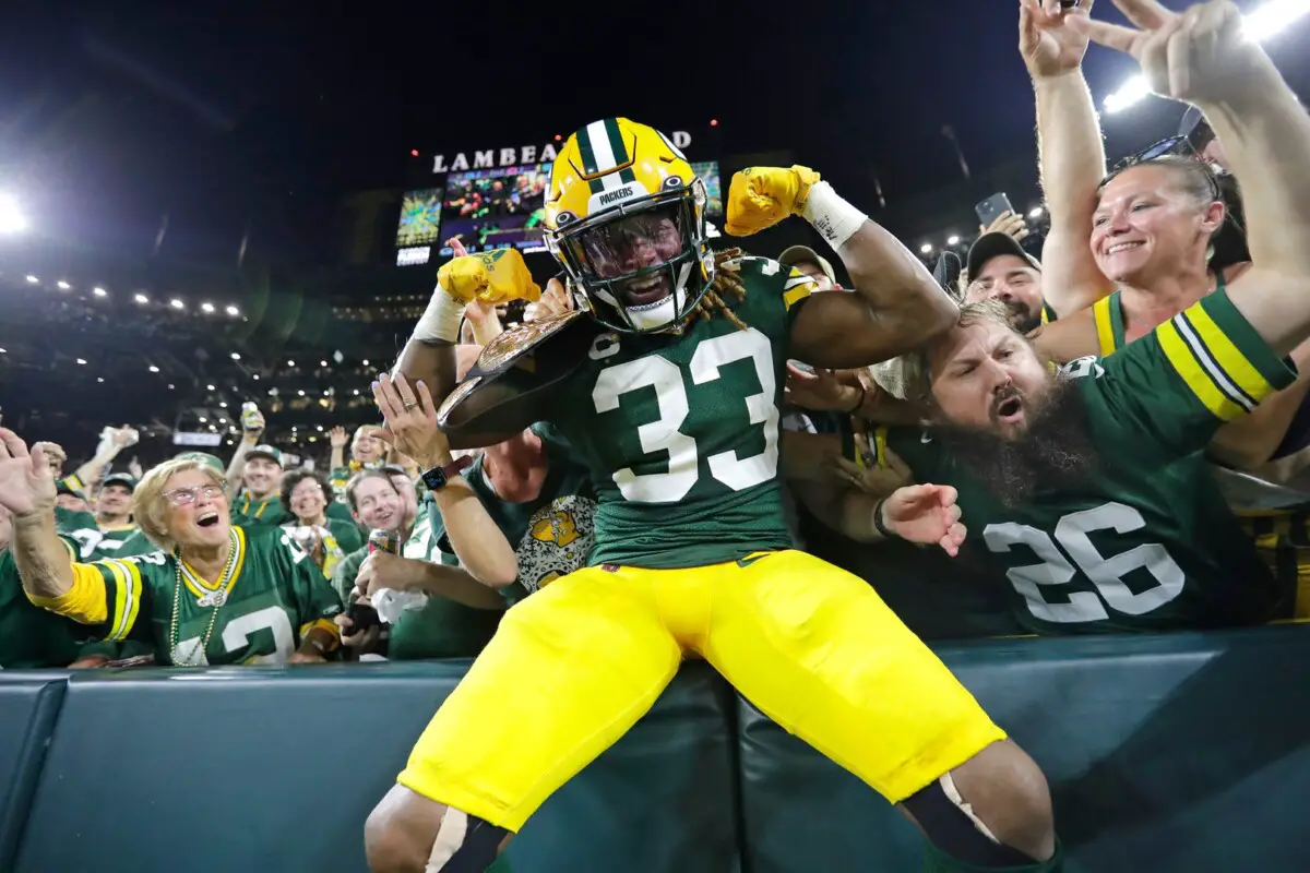 Green Bay Packers running back Aaron Jones (33) celebrates with fans after scoring a touchdown against the Chicago Bears in the second quarter during their football game Sunday, September 18, 2022, at Lambeau Field in Green Bay, Wis. Dan Powers/USA TODAY NETWORK-Wisconsin (NFL)