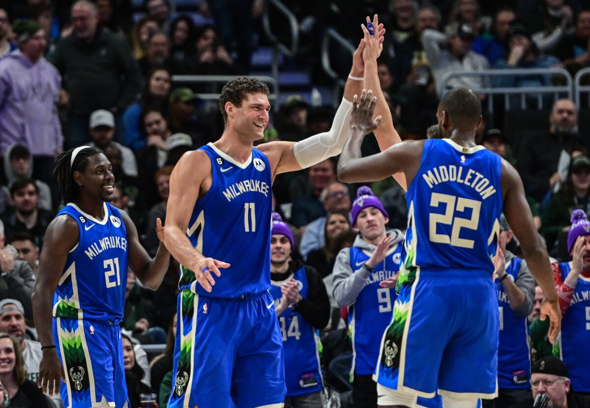 Dec 7, 2022; Milwaukee, Wisconsin, USA; Milwaukee Bucks center Brook Lopez (11) celebrates with Milwaukee Bucks guard Jrue Holiday (21) and forward Khris Middleton (22) after a score in the fourth quarter during game against Sacramento Kings at Fiserv Forum. Mandatory Credit: Benny Sieu-USA TODAY Sports (NBA News)