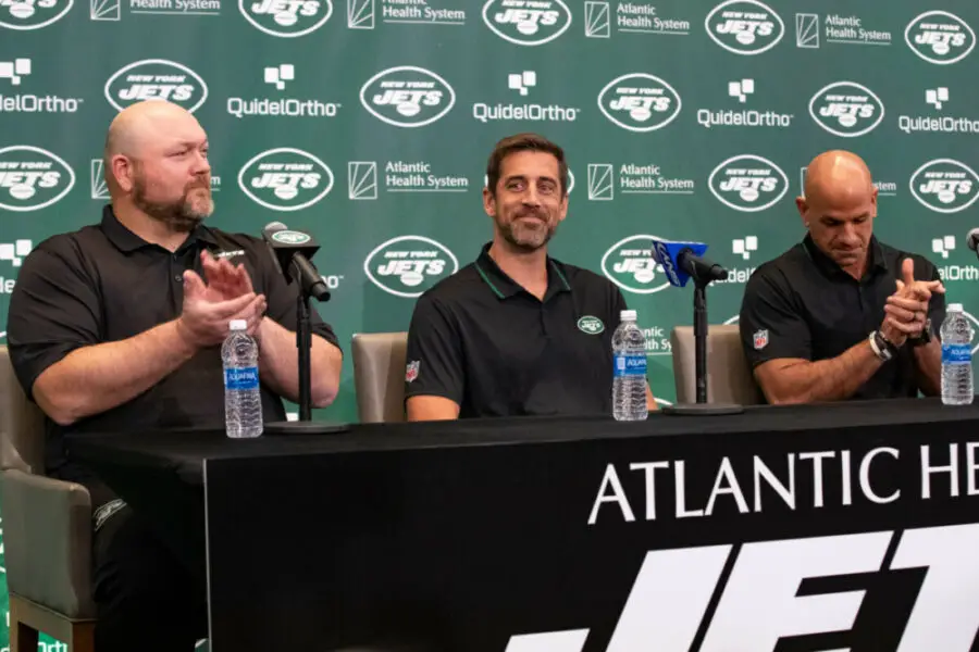 Apr 26, 2023; Florham Park, NJ, USA; New York Jets quarterback Aaron Rodgers (8) (center) is introduced during the introductory press conference alongside general manager Joe Douglas (left) and head coach Robert Saleh (right) at Atlantic Health Jets Training Center. Mandatory Credit: Tom Horak-USA TODAY Sports