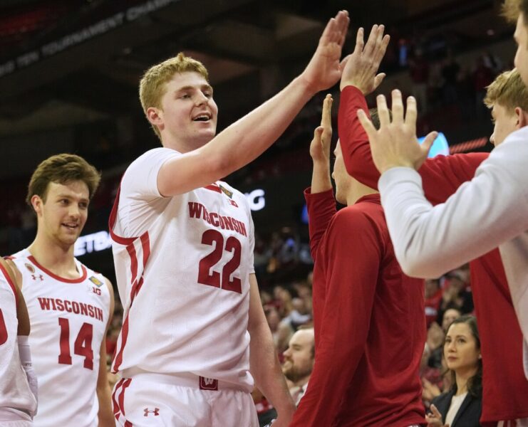 March 14, 2023; Madison, Wisconsin, USA; Wisconsin Badgers forward Steven Crowl (22) is congratulated by teammates during the second half of their opening round game of the National Invitation Tournament against the Bradley Braves at the Kohl Center. Wisconsin beat Bradley 81-62. Mandatory Credit: Mark Hoffman - USA Today Sports