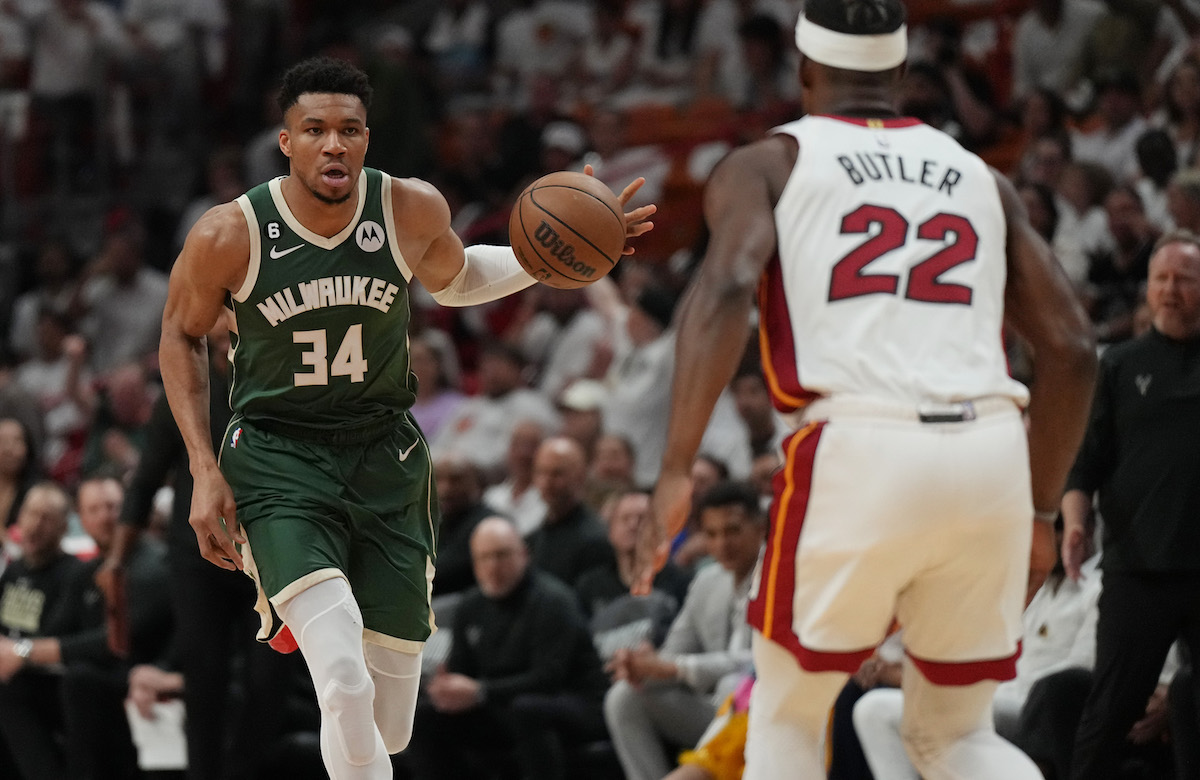 Apr 24, 2023; Miami, Florida, USA; Milwaukee Bucks forward Giannis Antetokounmpo (34) brings the ball up the court as Miami Heat forward Jimmy Butler (22) defends in the first quarter during game four of the 2023 NBA Playoffs at Kaseya Center. Mandatory Credit: Jim Rassol-USA TODAY Sports (NBA News)